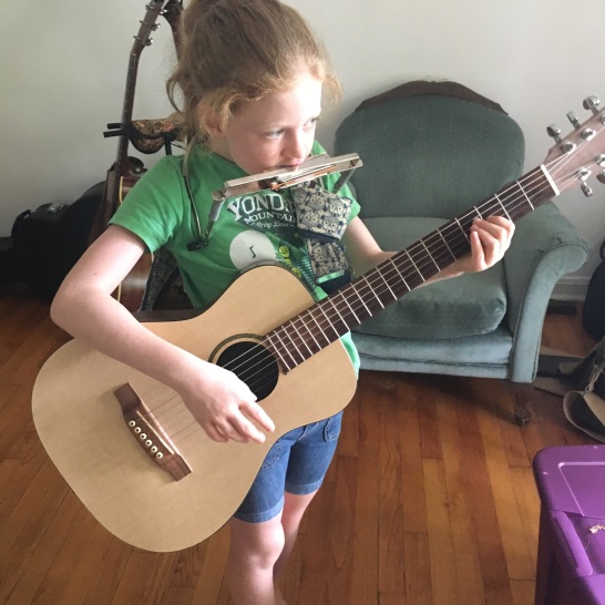 Lily, Mitch's daughter playing music